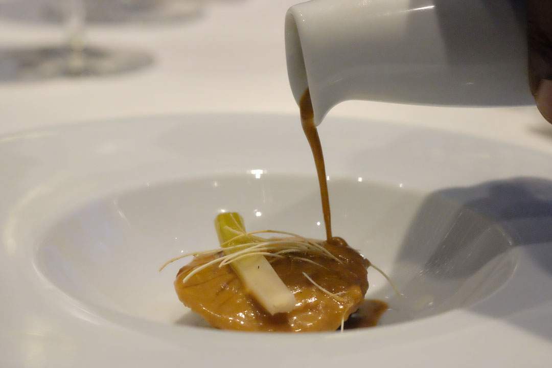 Alaskan King Crab and Foie Gras Ravioli Stewed Leeks in Vinaigrette Lightly Creamed “Lobster Jus – Soup”